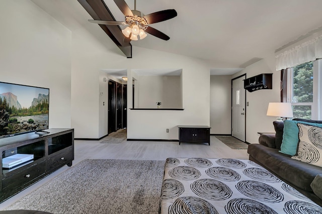 living area with lofted ceiling, ceiling fan, baseboards, and light wood-type flooring