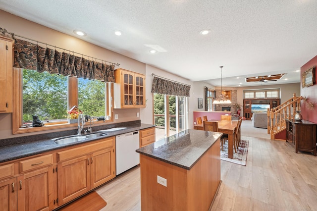 2374 Thrush St, Shakopee, MN 55379 - kitchen with white dishwasher, a sink, a textured ceiling, a kitchen island, and recessed lighting