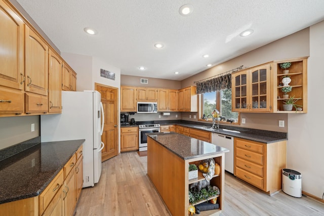 2374 Thrush St, Shakopee, MN 55379 - kitchen featuring open shelves, appliances with stainless steel finishes, a sink, a center island, and dark stone countertops