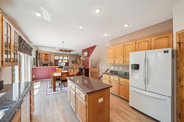 2374 Thrush St, Shakopee, MN 55379 - kitchen with white appliances, light wood-style flooring, a textured ceiling, a kitchen island, and recessed lighting
