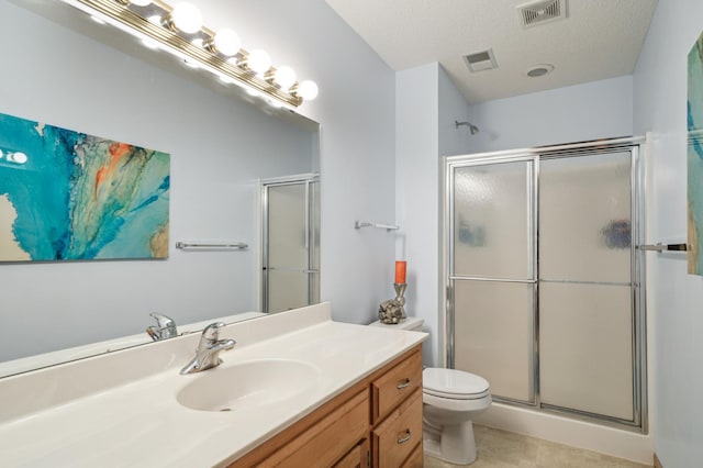 2374 Thrush St, Shakopee, MN 55379 - bathroom with a stall shower, vanity, toilet, and a textured ceiling