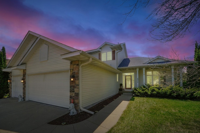 2374 Thrush St, Shakopee, MN 55379 - view of front facade featuring an attached garage, concrete driveway, stone siding, a lawn, and roof with shingles