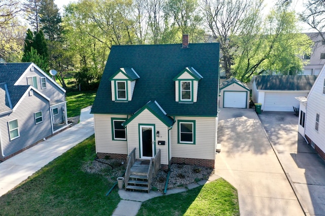 cape cod-style house with a chimney, an outdoor structure, roof with shingles, driveway, and a detached garage