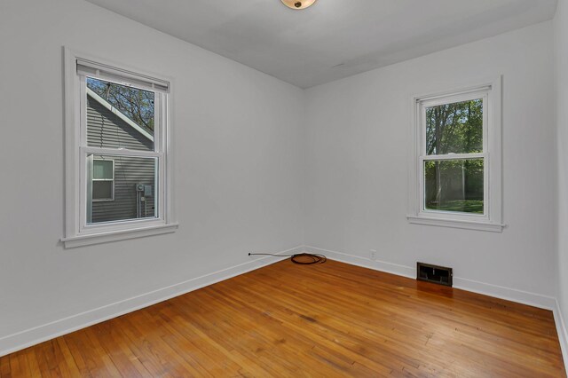 spare room featuring baseboards and plenty of natural light