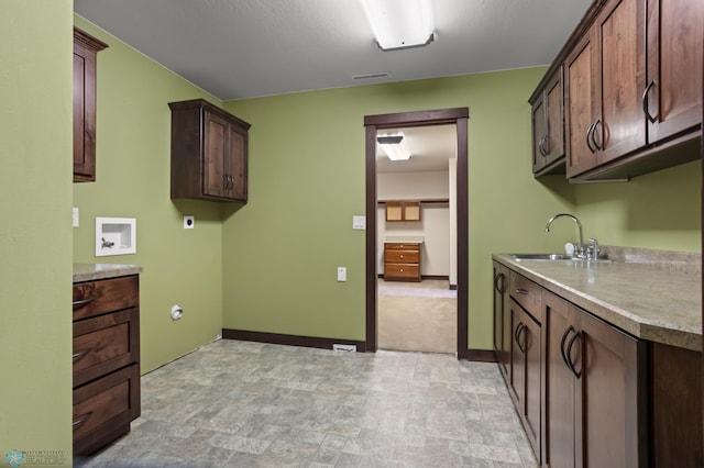 laundry room with cabinet space, hookup for an electric dryer, stone finish floors, washer hookup, and baseboards