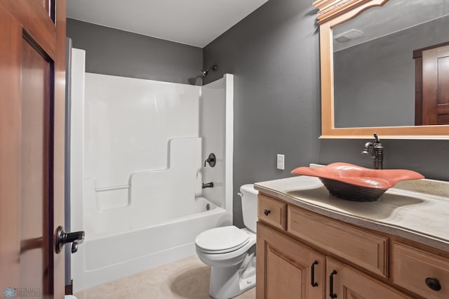 full bath featuring tile patterned flooring, toilet, washtub / shower combination, and vanity