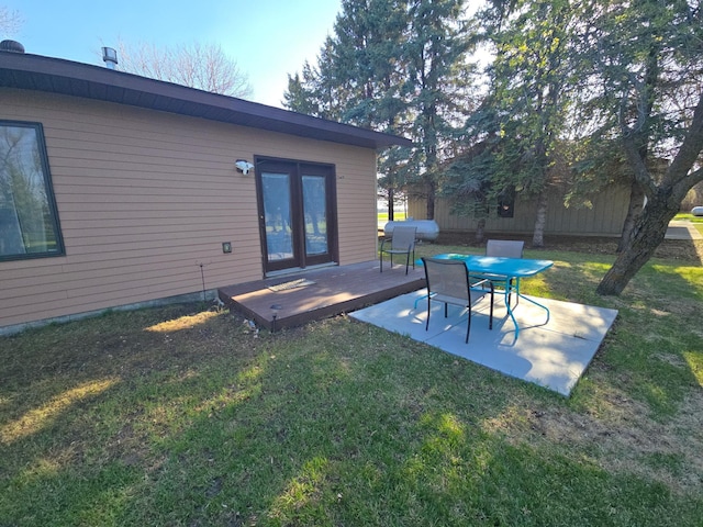 exterior space with a lawn, a patio, and a wooden deck