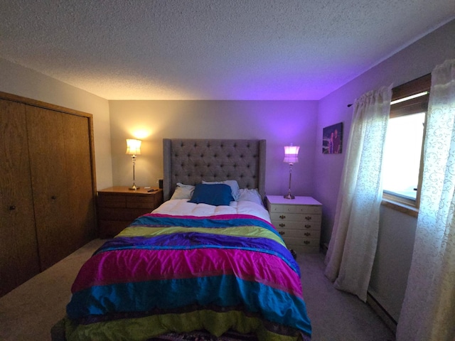 bedroom featuring carpet, a textured ceiling, and a closet