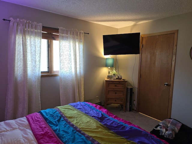 carpeted bedroom featuring a textured ceiling
