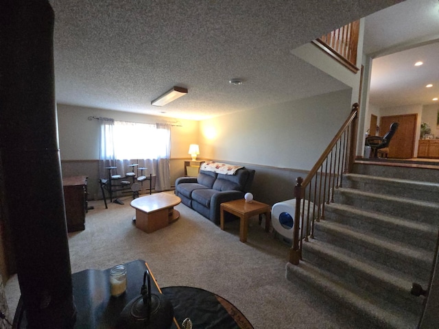 carpeted living area featuring a textured ceiling, stairway, and recessed lighting