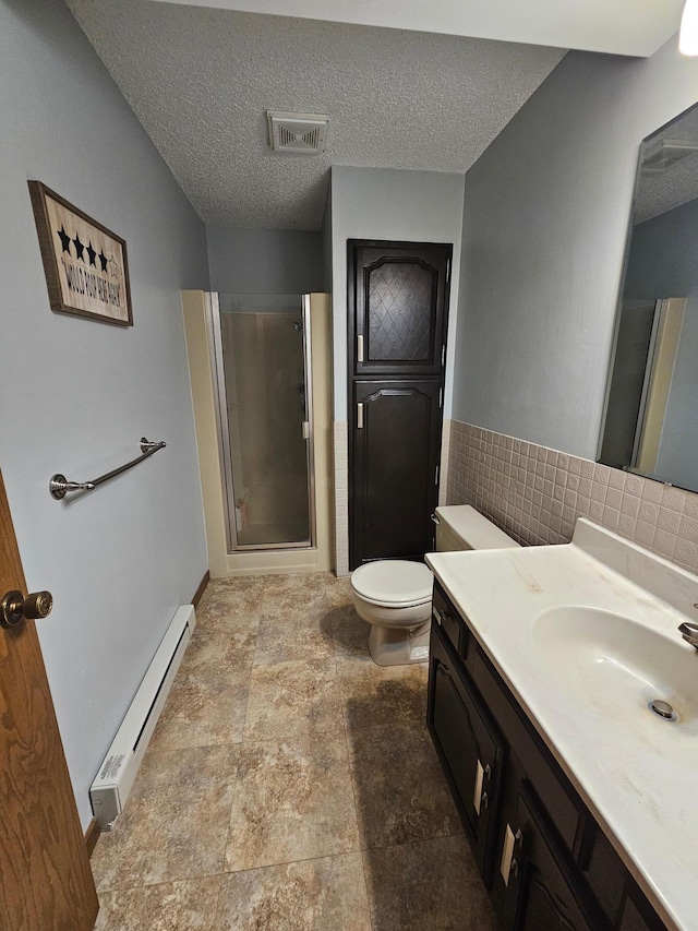 full bath with toilet, a stall shower, a baseboard radiator, visible vents, and vanity