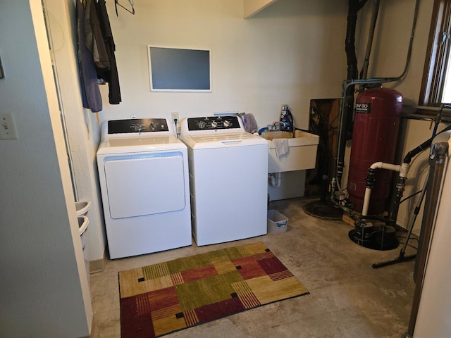 laundry area with independent washer and dryer, a sink, and laundry area
