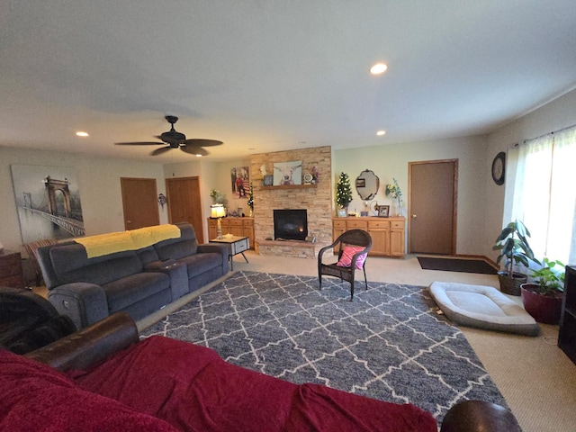 living room with recessed lighting, a stone fireplace, ceiling fan, and carpet