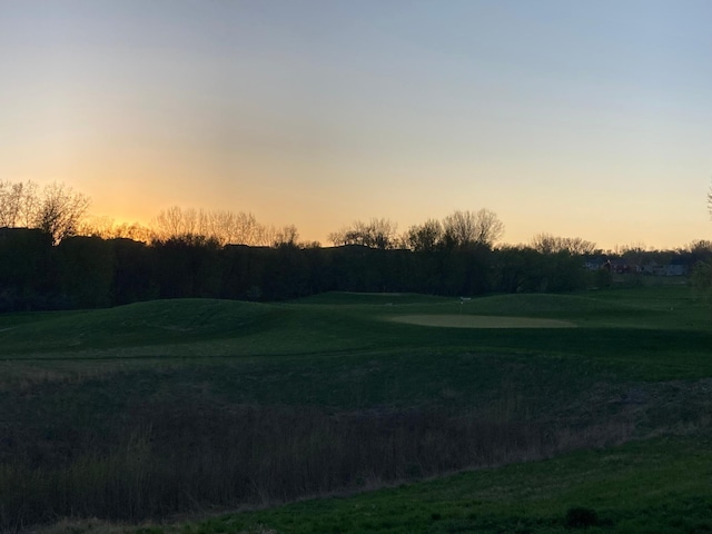 view of home's community featuring golf course view and a putting green