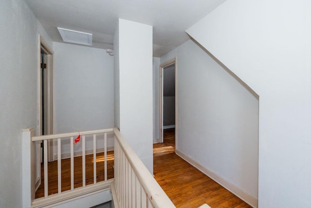 hall featuring visible vents and wood finished floors
