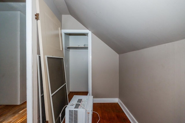 additional living space featuring vaulted ceiling and wood finished floors
