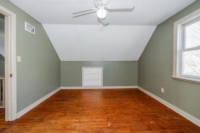 bonus room featuring vaulted ceiling, wood finished floors, and visible vents