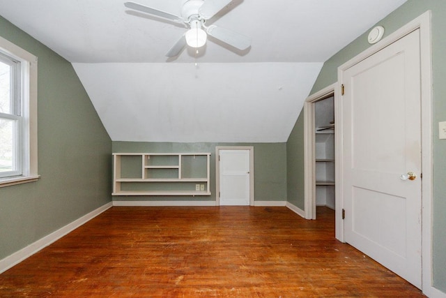 bonus room with baseboards, a healthy amount of sunlight, wood finished floors, and vaulted ceiling