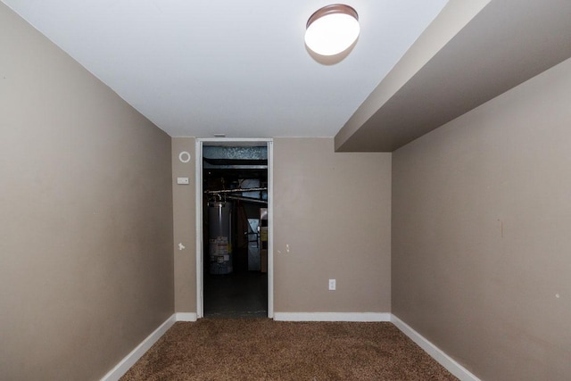 interior space with water heater, baseboards, and carpet floors