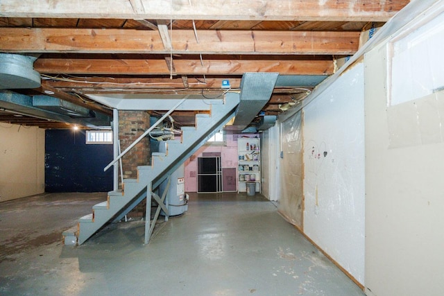 basement featuring stairway and gas water heater
