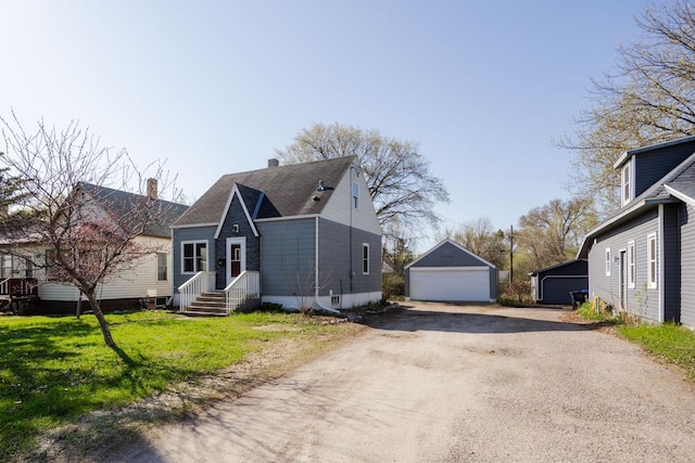 view of front of property featuring a front yard, an outbuilding, a chimney, and a garage