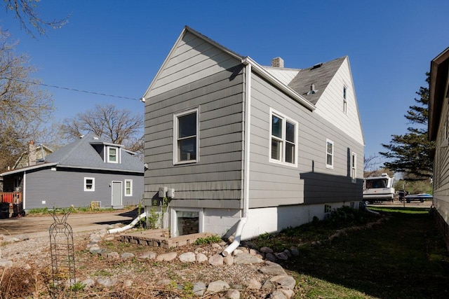 view of property exterior featuring a chimney