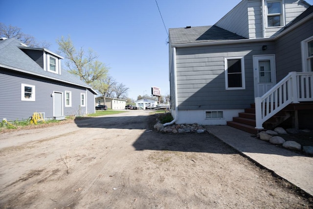 view of home's exterior with driveway and a residential view