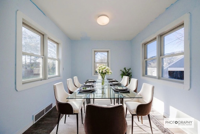 dining area featuring baseboards, visible vents, plenty of natural light, and wood finished floors