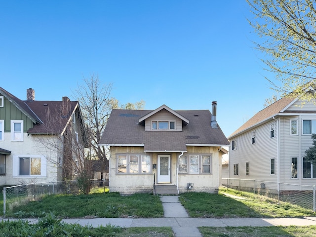 bungalow-style home with a shingled roof and stucco siding