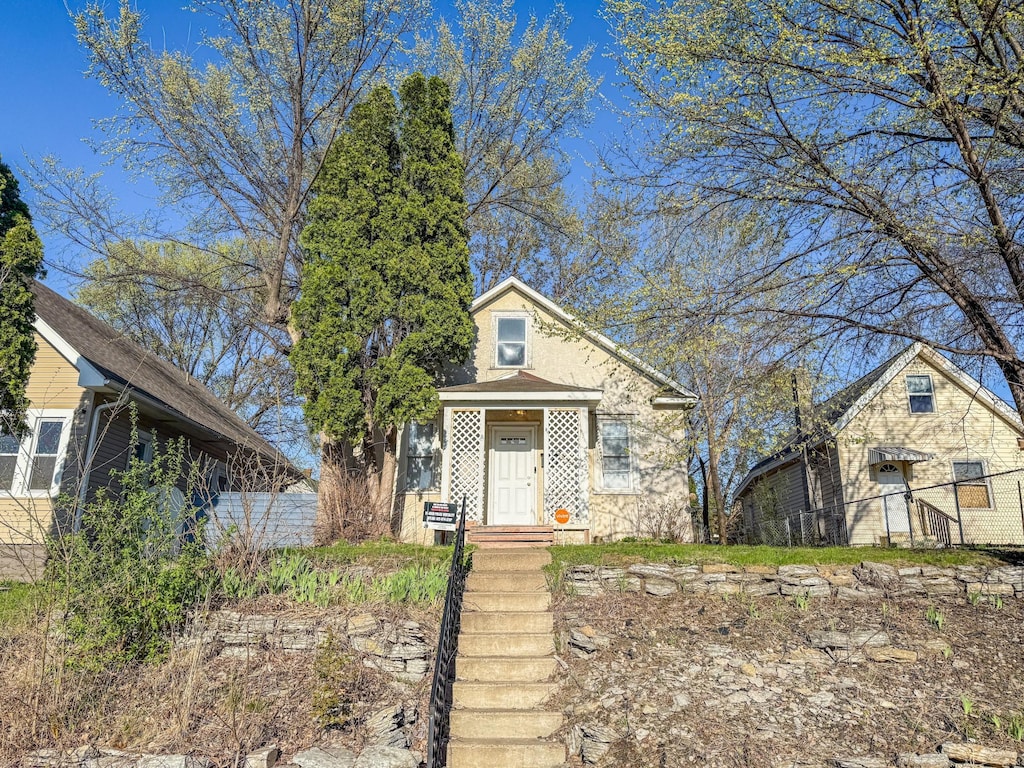 bungalow-style house featuring fence