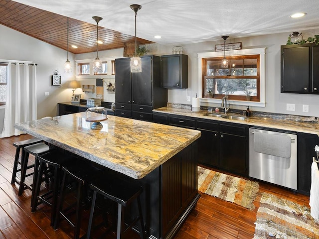1535 148th Ln NE, Ham Lake, MN 55304 - kitchen with a sink, stainless steel dishwasher, dark cabinets, a kitchen breakfast bar, and dark wood finished floors