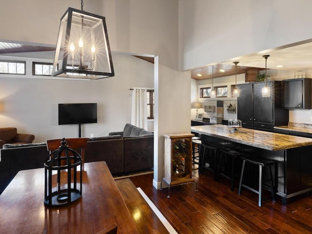 1535 148th Ln NE, Ham Lake, MN 55304 - kitchen with dark wood-type flooring, a kitchen breakfast bar, pendant lighting, a center island, and open floor plan