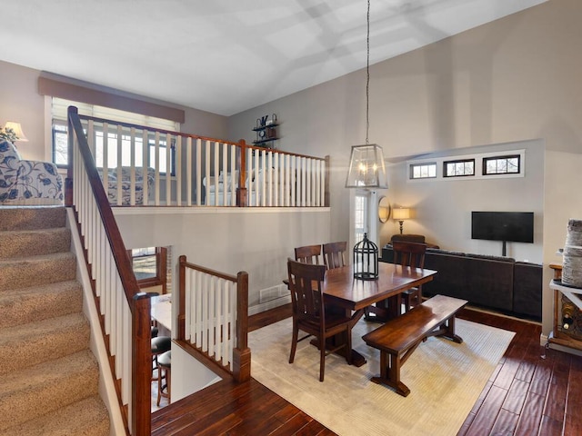 1535 148th Ln NE, Ham Lake, MN 55304 - dining room featuring a chandelier, hardwood / wood-style floors, stairs, and a high ceiling