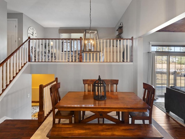 1535 148th Ln NE, Ham Lake, MN 55304 - dining space featuring hardwood / wood-style flooring, stairway, and a chandelier