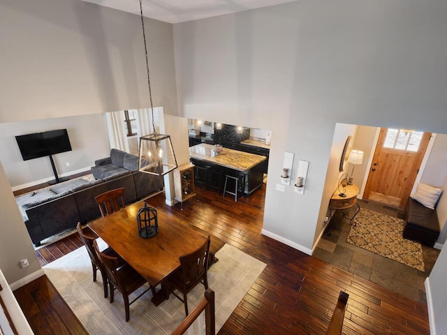 1535 148th Ln NE, Ham Lake, MN 55304 - dining space featuring a towering ceiling, wood-type flooring, and baseboards