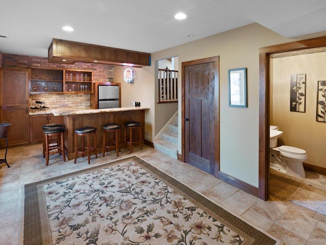 1535 148th Ln NE, Ham Lake, MN 55304 - indoor wet bar featuring freestanding refrigerator, baseboards, recessed lighting, stairway, and backsplash