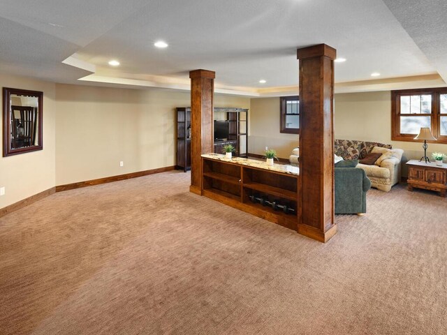 1535 148th Ln NE, Ham Lake, MN 55304 - carpeted living area with a tray ceiling, recessed lighting, ornate columns, and baseboards