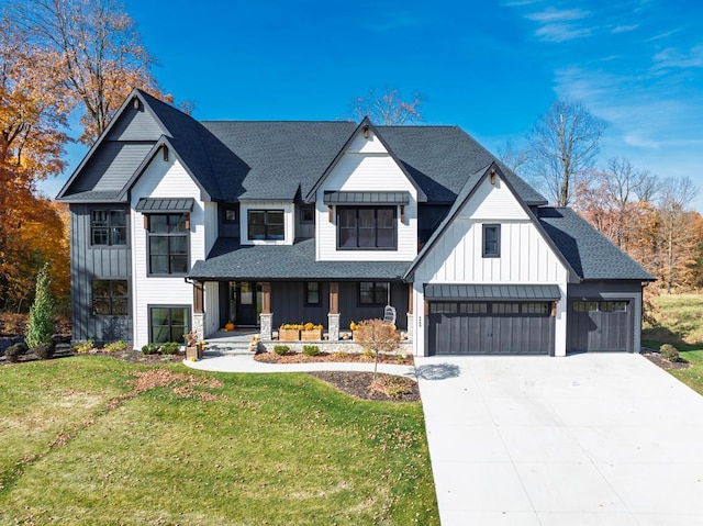 modern inspired farmhouse featuring a porch, a front yard, a shingled roof, and board and batten siding