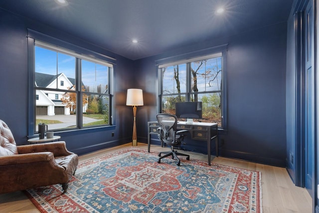 office space with recessed lighting, a wealth of natural light, and wood finished floors