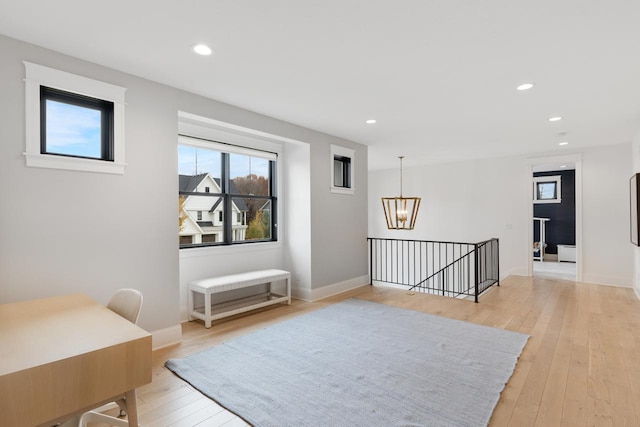 living area with light wood finished floors, a notable chandelier, an upstairs landing, and recessed lighting