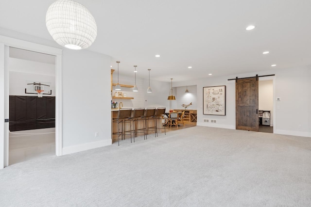 carpeted living room with a barn door, baseboards, and recessed lighting
