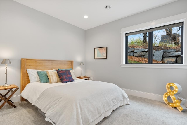 carpeted bedroom featuring baseboards and recessed lighting