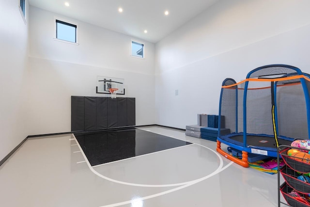 view of sport court featuring a trampoline and a healthy amount of sunlight