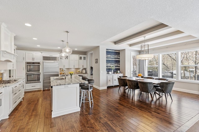1105 Brown Rd S, Orono, MN 55391 - kitchen with a textured ceiling, appliances with stainless steel finishes, baseboards, and a sink