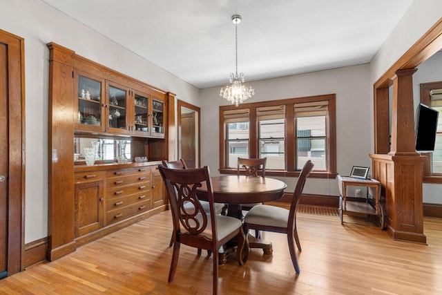 1520 Randolph Ave, Saint Paul, MN 55105 - dining space featuring light wood finished floors, plenty of natural light, baseboards, and a chandelier