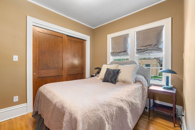 1520 Randolph Ave, Saint Paul, MN 55105 - bedroom featuring ornamental molding, wood finished floors, a closet, and baseboards