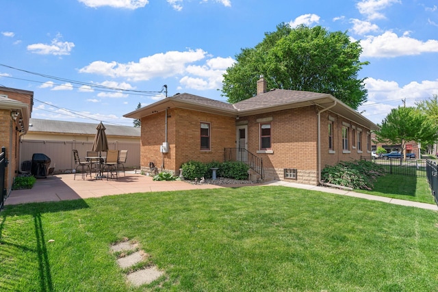 1520 Randolph Ave, Saint Paul, MN 55105 - rear view of house featuring brick siding, a patio, and a chimney