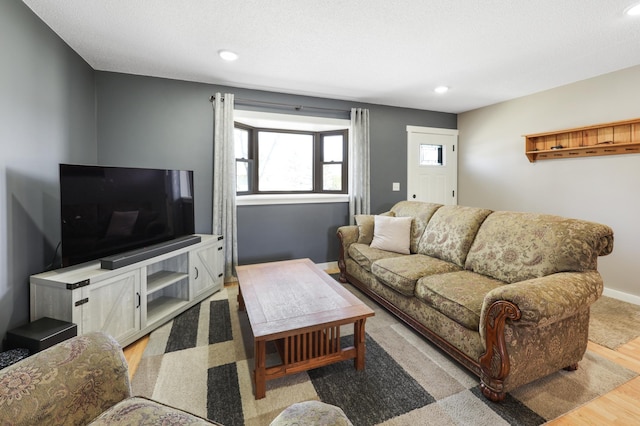 living room with baseboards, light wood-style floors, and recessed lighting
