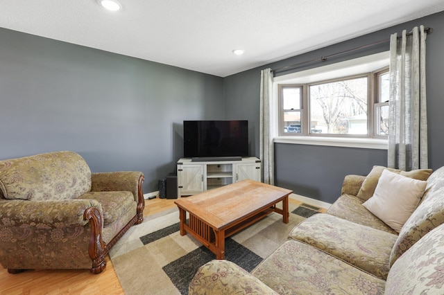 living room with recessed lighting, baseboards, and wood finished floors