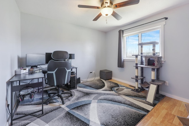 office with baseboards, a ceiling fan, and wood finished floors